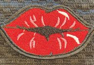 An image of a needlepoint picture of red lips