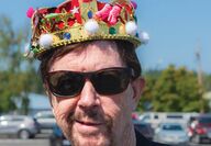 Portrait of Tom Robbins wearing crown