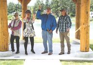 Two women and two men cut the ribbon to open a park pavilion
