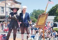 Parade participants dress as two Founding Fathers