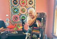 A woman shows a quilt