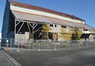 Cyclone fence surrounds an old building