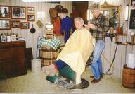 A barber cutting a customer's hair.