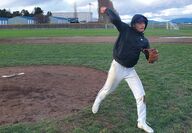 A boy pitches a baseball