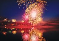 Fireworks fill the sky and reflect on the Swinomish Channel