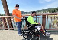 Bob Grace, left, pushes Francis Sylvester in his wheelchair