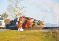 A locomotive is tipped on its side after derailing
